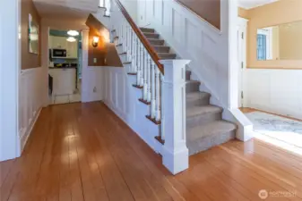Staircase looking into hallway & kitchen (storage under stairs)