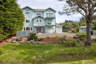 The first things one will notice upon arrival are the lovely landscaping in the front, ample parking, and a green house!