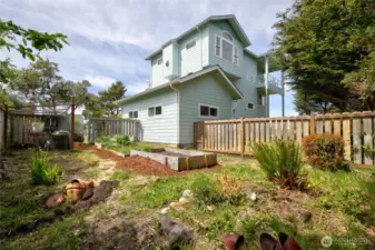 The SE corner of the property along/behind the garage space is fenced in and turned into a garden area.