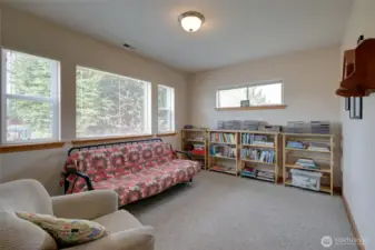 The first floor features a family room overlooking the front garden and firepit area.