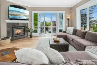 This great room flows from the main floor hallway and is open to the kitchen and nook, making it the perfect space for entertaining. Note the double doors to the balcony, gas fireplace (one of four), and refinished hardwood floors.