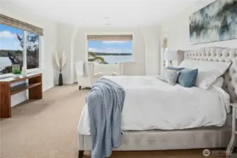 Wow! The primary suite is sweet indeed! When you enter the spacious bedroom, you see sweeping lake views through the large windows. The window in the center of the photo has been a favorite space to relax and watch boats, float planes, and the resident eagles and other wildlife. Imagine waking up to this every day!