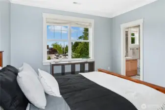 This large bedroom on the upper level has plenty of space for dressers and shelving, along with an ensuite bath.
