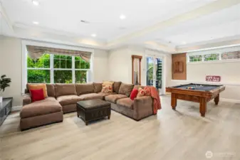 This spacious rec room was completely renovated in May 2025 and is a wonderful place to hang out, play pool (pool table is negotiable), watch television and relax. Note door with spiral staircase to take you up to the main floor kitchen or to the upper level primary suite view deck. Flooring is luxury vinyl tile...ideal for wet feet coming in from the lake!