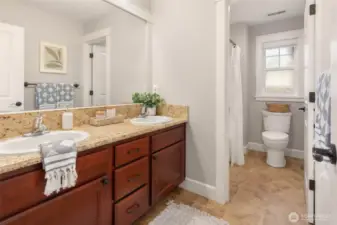 Dual vanity, full bathroom on upper level. 2 additional bedrooms share this bathroom.