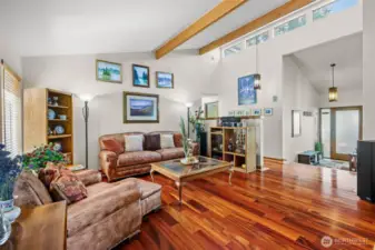 Living room with vaulted ceiling and extra windows for brightness.