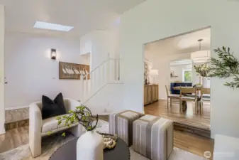 Vaulted ceiling living room with skylights.