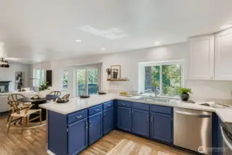 Open concept kitchen with quartz counters.