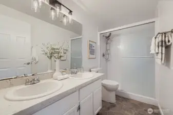 Primary en-suite bath with quartz counters.