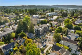 Territorial view with Seattle skyline and Cascade mountains in the distance. Home is in center of photo.