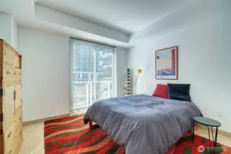Spacious bedroom with sliders to balcony.