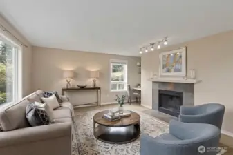 Open concept living with cozy wood fireplace this living room includes a built-in desk. *Room is digitally staged.