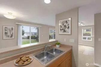 View of open concept layout from kitchen. *decor is digitally staged.