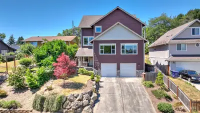 Great curb appeal with mature landscaping & large two-car garage.