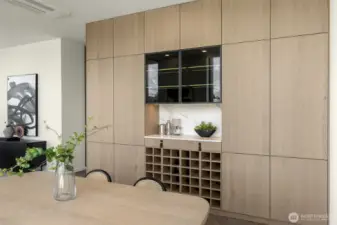 High-end custom cabinetry features Bavaria Oak wood veneer, custom wine storage, lighting and push-to-open cabinets