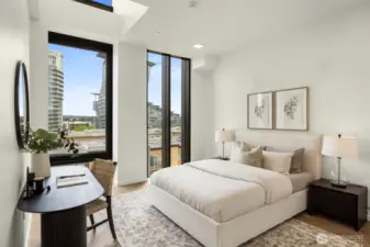 Primary bedroom features floor-to-ceiling windows, chevron engineered white oak floors and a walk-in-closet.