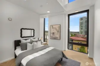 Secondary bedroom features vaulted ceilings, operable windows and a large nook that may be utilized as an office space or closet.