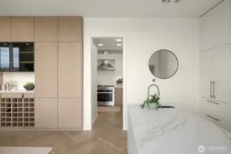 High-end custom cabinetry features Bavaria Oak wood veneer, custom wine storage, lighting and push-to-open cabinets
