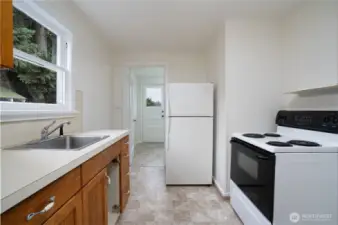 Kitchen features new linoleum and fresh paint. Kitchen appliances stay. (Owner is having a replacement cabinet door made to match)
