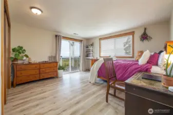 Another shot of lower bedroom with view of city and bay, plus private deck