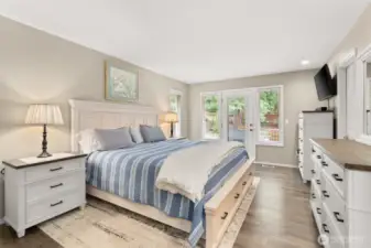 Comfortable primary bedroom with walk out access to private deck.