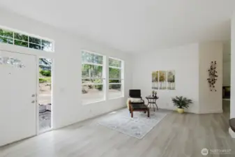Spacious living room with laminate flooring and abundant natural light.