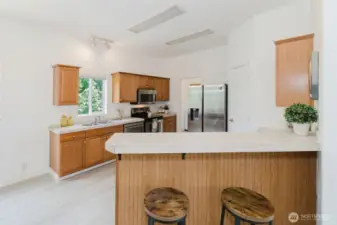 Bright kitchen with ample cabinetry and laminate flooring throughout.