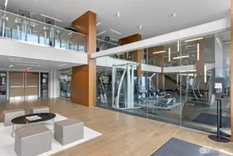 Stay fit in the expansive two-floor gym featuring free weights, machines, treadmills, and city views.