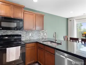 KITCHEN - Stone Counter serve-over, tile backsplash, SS sink & Dishwasher