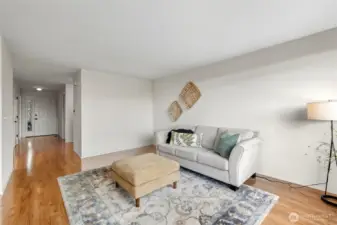 Looking across the living room toward the front entry with bedrooms on either side.