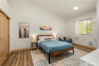 Vaulted ceilings and dual closets highlight the primary suite, complete with peaceful backyard views.