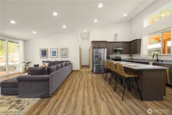 Wide-plank LVP flooring combines durability and style throughout. The split floor plan keeps the primary suite separate from two guest bedrooms on opposite sides of the house, ensuring comfort and privacy.