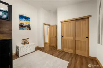 Bedroom 2 features a vaulted ceiling, full-size closet, and views of the backyard.
