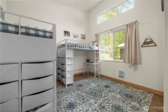 Bedroom 3 features a soaring 15' vaulted ceiling, full-size closet, and abundant natural light.
