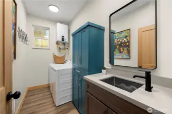 Convenient laundry/utility room houses the tankless propane water heater for instant hot water, with additional storage cabinets added in 2025.