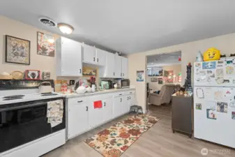 Unit 3 - Refreshed kitchen with LVP flooring, painted cabinets, quartz counters, and newer hardware.
