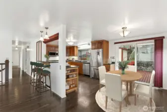 Open Concept Kitchen: Remodeled kitchen with an integrated eating bar, sleek cabinetry, and a seamless flow into the dining and living areas