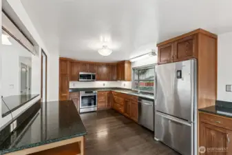 Open Concept Kitchen: Remodeled kitchen with an integrated eating bar, sleek cabinetry, and a seamless flow into the dining and living areas