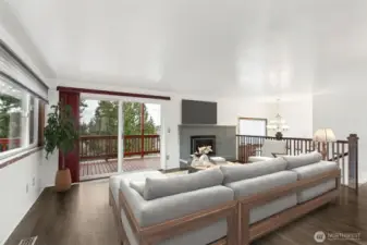 Living Room: Bright and airy living space featuring a gas fireplace and oversized sliding glass doors that perfectly frame the water views.