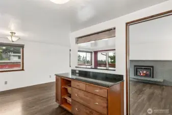 Living Room: Bright and airy living space featuring a gas fireplace and oversized sliding glass doors that perfectly frame the puget sound and territorial views.