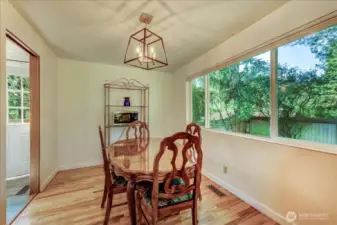 Wood floors in formal dining area with view of westerly side yard