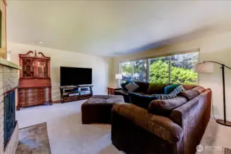 Living room view two with large picture window and built-in bookcase