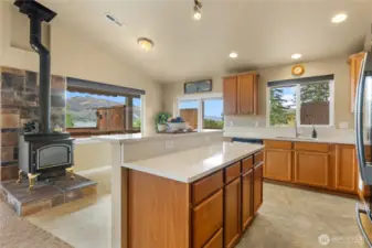 Kitchen/dining with sliding door access to the deck and hot tub. Wood stove upstairs
