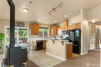 Kitchen/dining with sliding door access to the deck and hot tub. Wood stove upstairs