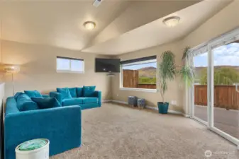 Living room adjacent the kitchen with access to the deck through slider with Lakeview.