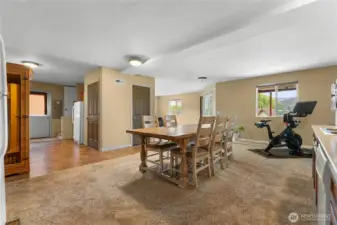 Basement kitchen and dining area, patio access door to the left and stairs to the upper level directly to the right of that outside door