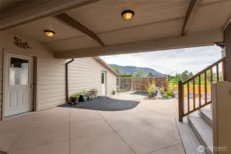 First door to the left is entry into the garage, Far door is entry into workshop, steps to the right are access into the house.
