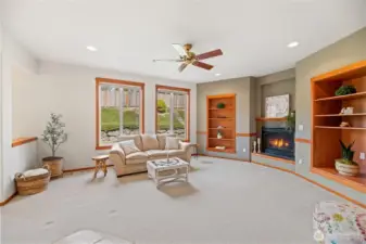 Family room with gas fireplace and ceiling fan