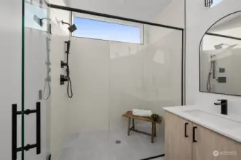 Step into a spacious, glass-enclosed walk-in shower with modern fixtures and clean lines—a private sanctuary for relaxation.