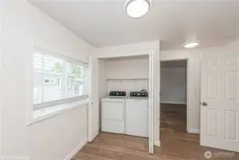 Convenient laundry area tucked inside a closet, keeping things neat and easily accessible.